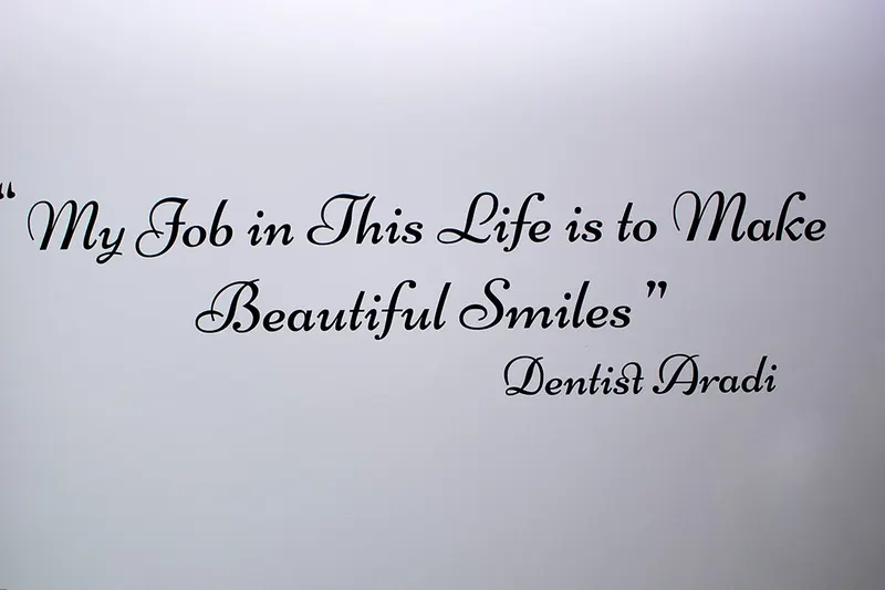 Words painted on a clinic wall: My job in this life is to make beautiful smiles. Dentist Aradi