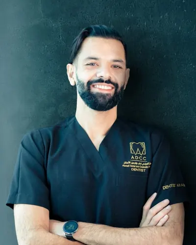 Portrait of Dr. Mohammed Alaradi in navy clinic scrubs