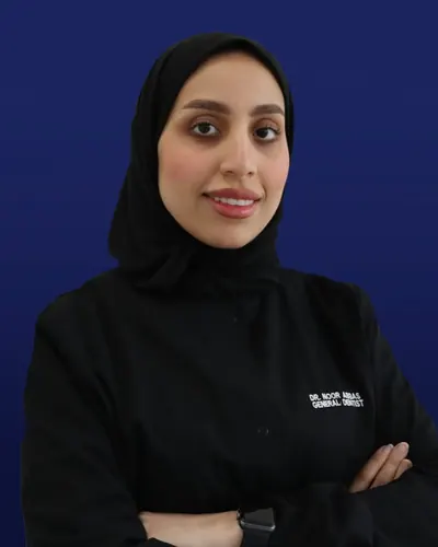 Portrait of Dr. Noor Abbas in black clinic scrubs